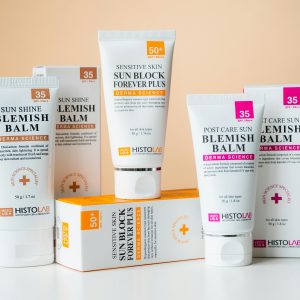 A collection of skincare products including blemish balms and sunblock for sensitive skin with SPF protection.