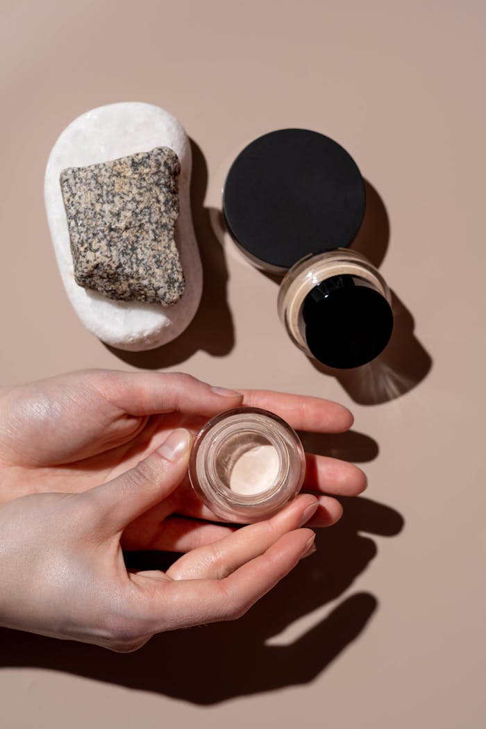 Minimalist display of skincare and cosmetic products with a focus on natural textures and elegance.